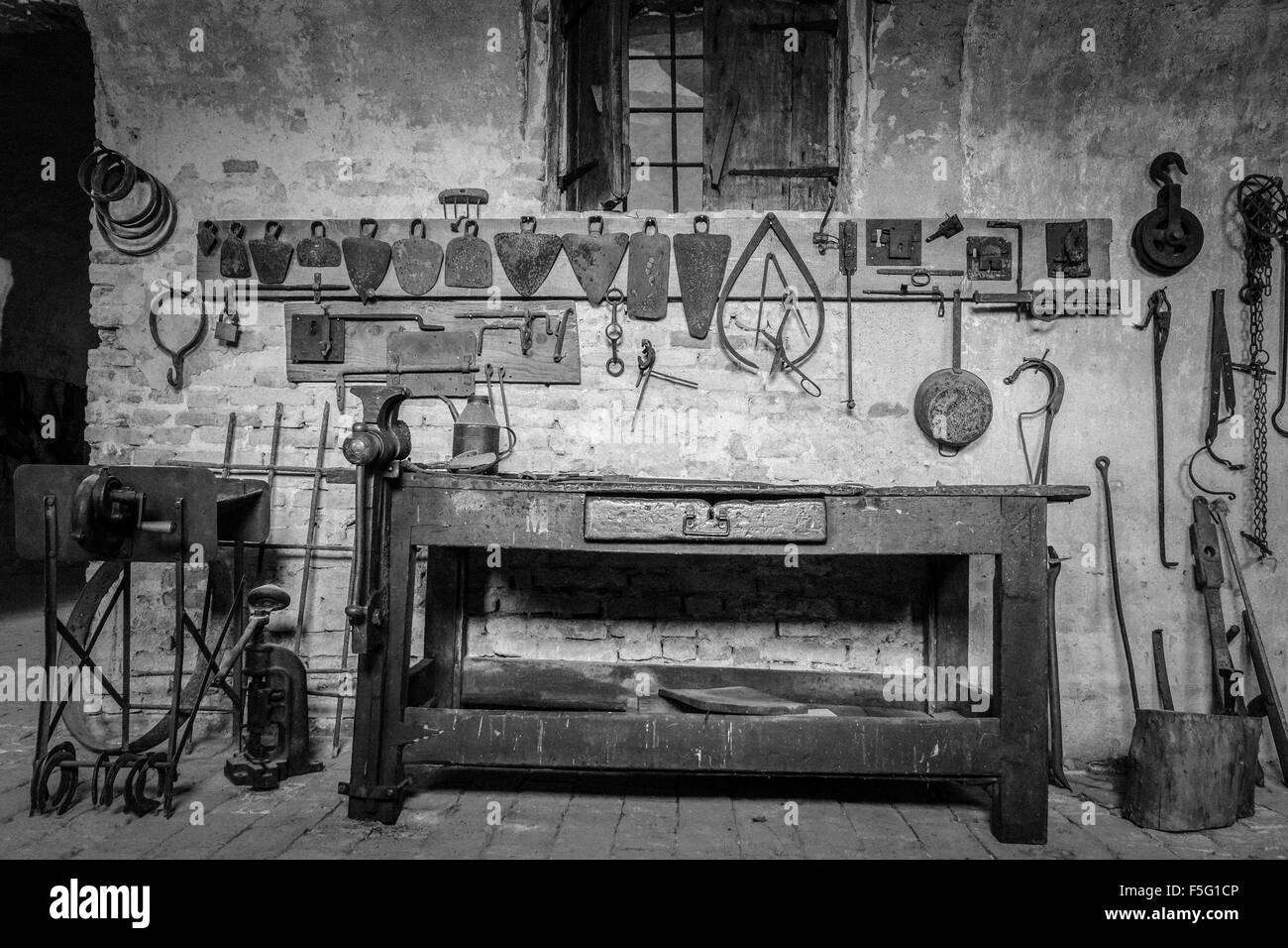 Old wooden workbench with tools with black and white retrò ...