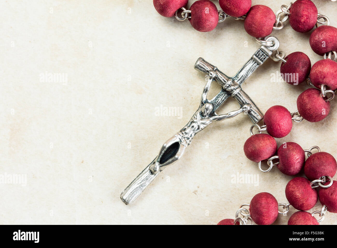 Catholic rosary on old paper background with copy-space Stock Photo - Alamy