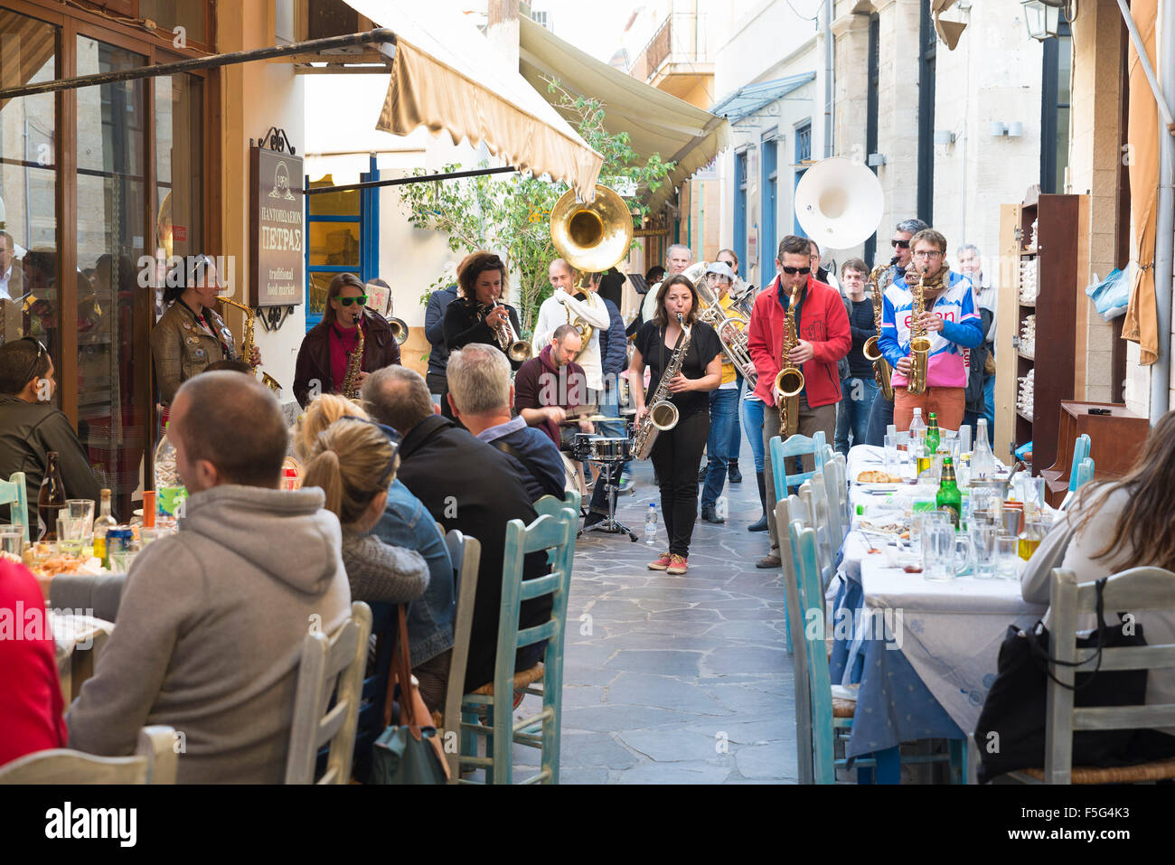 AEGINA, GREECE - OCTOBER 25, 2015: Band of musicians played on the terrace of a restaurant Stock Photo