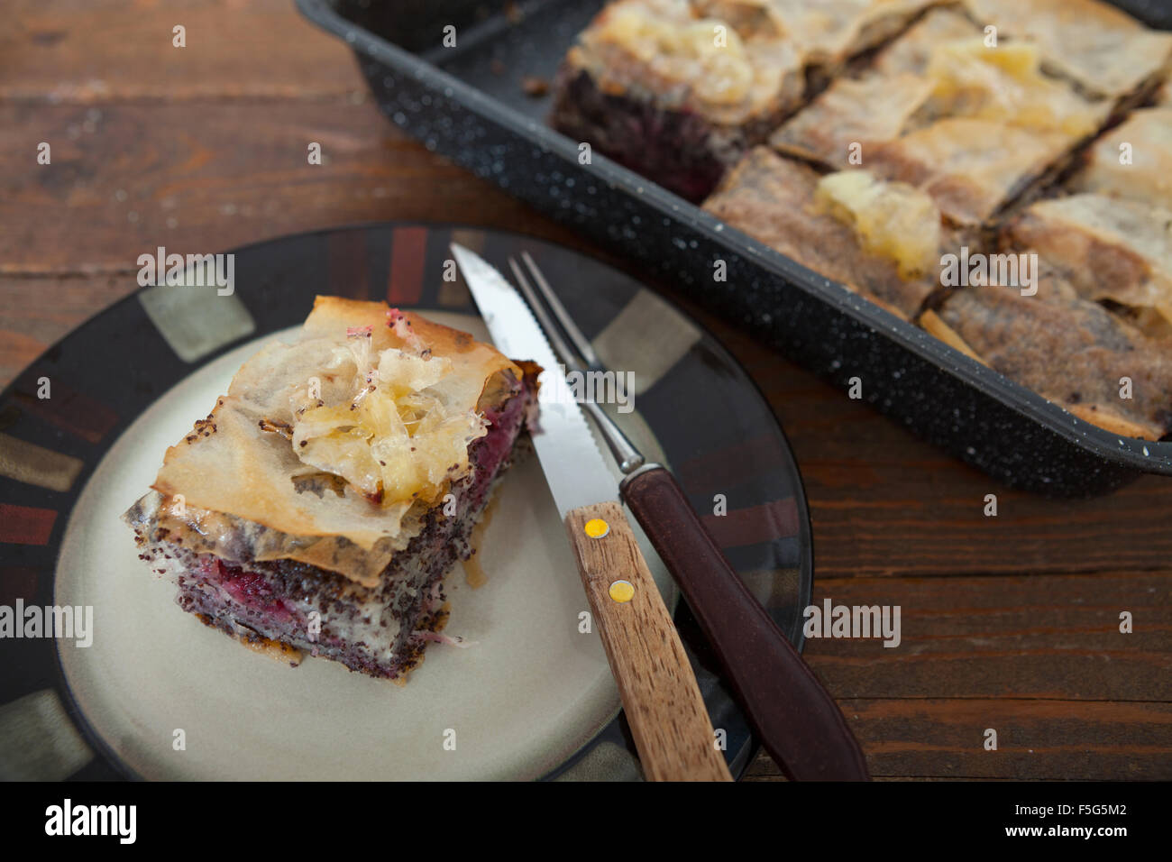 Homemade sweet pastry made of layers of filo filled with chopped nuts, poppy seed, cherry and