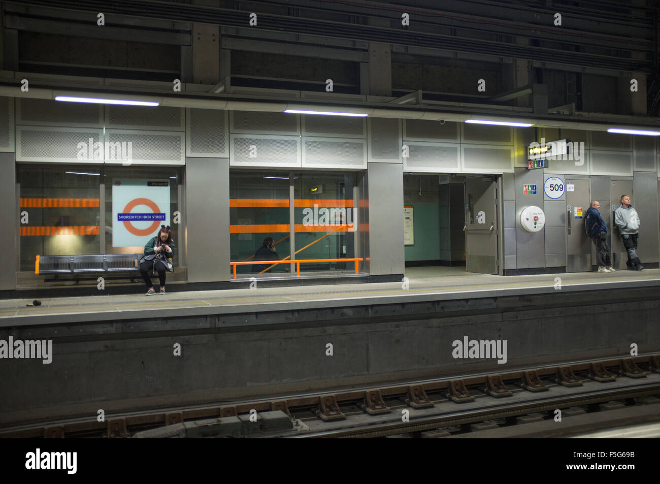 Waiting for a train at Shoreditch Tube station, London Stock Photo