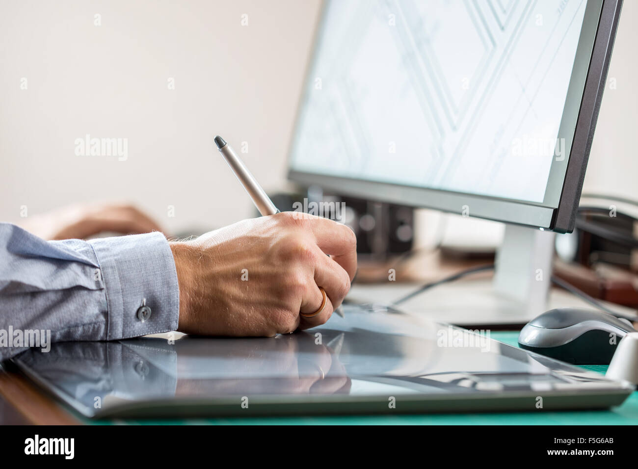 Person Using Graphics Tablet Graphic artist using graphics tablet at his desk Stock Photo - Alamy
