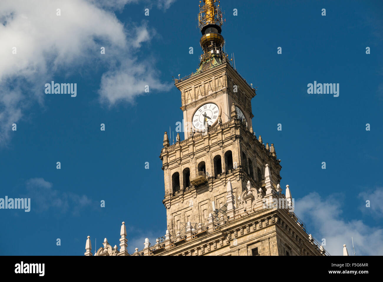top fragment of famous Warsaw landmark Palace of Culture and Science by daytime Stock Photo