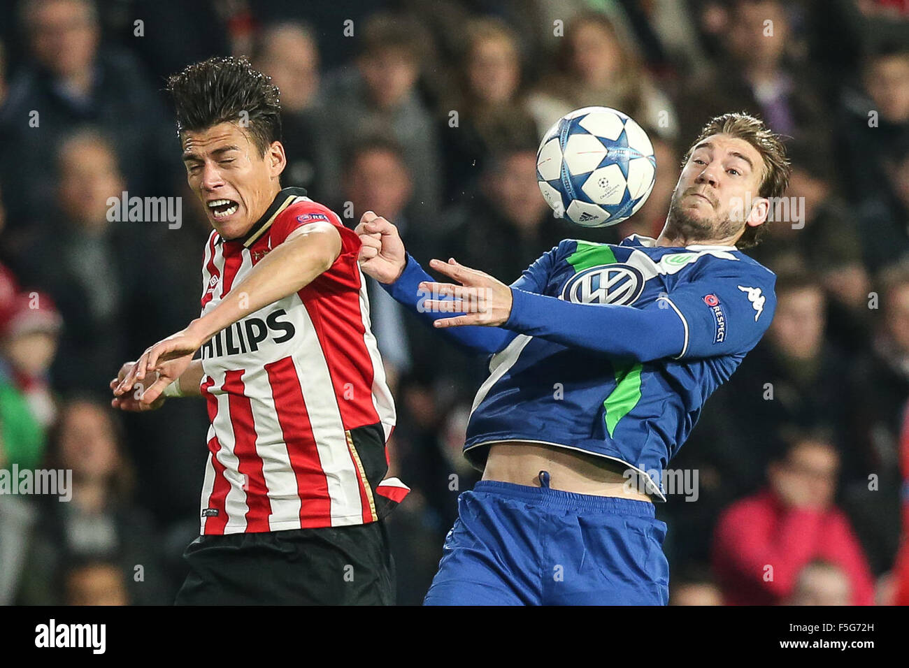 Eindhoven, The Netherlands. 03rd Nov, 2015. Nicklas Bendtner of Wolfsburg (r) and Hector Moreno, of Eindhoven vie for the ball during the UEFA Champions League Group B soccer match PSV Eindhoven and VfL Wolfsburg at the PSV Stadium in Eindhoven, The Netherlands, 03 November 2015. Photo: Maja Hitij/dpa/Alamy Live News Stock Photo