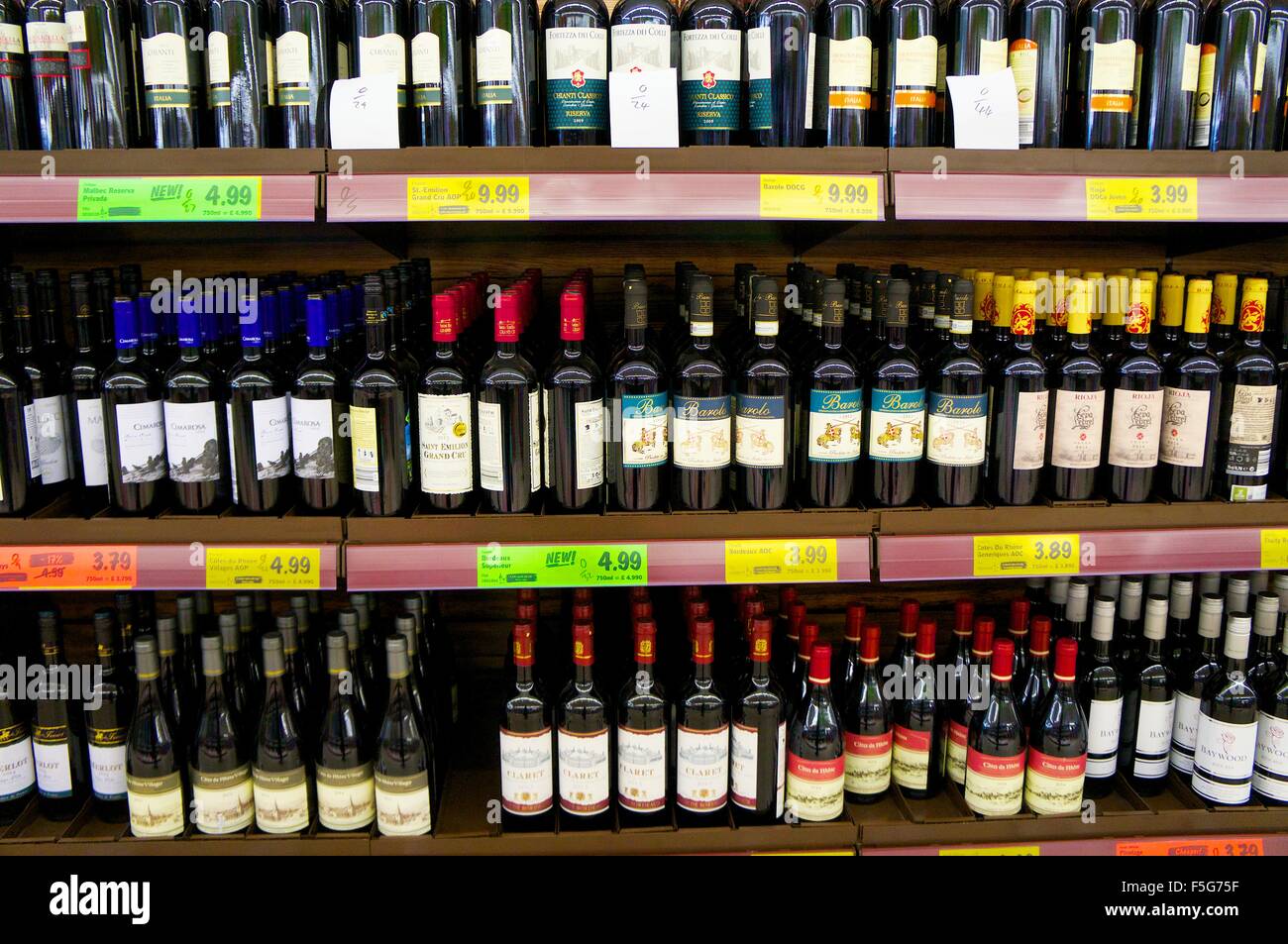 Supermarket wine shelves showing a selection of bottles of wine with price labels. Stock Photo