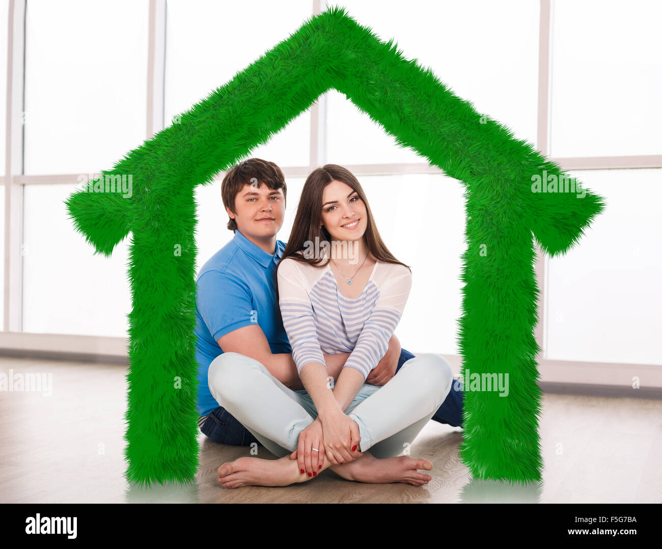 Young cute couple sitting on the floor Stock Photo - Alamy