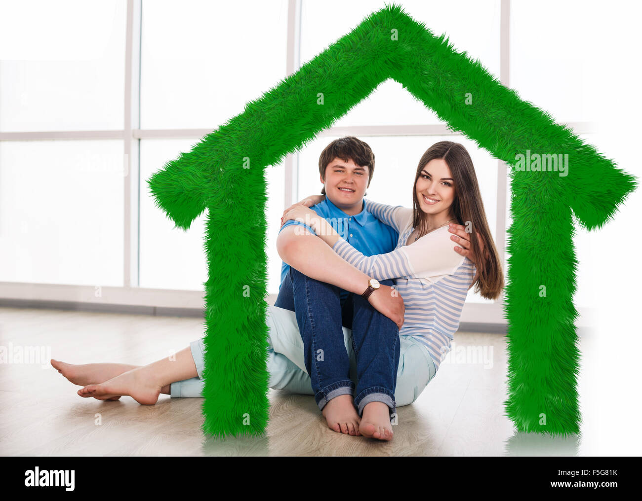 Young cute couple sitting on the floor Stock Photo - Alamy