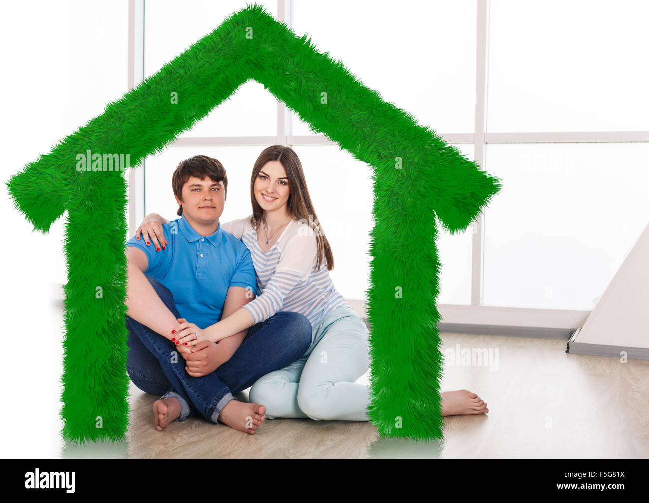 Young cute couple sitting on the floor Stock Photo - Alamy