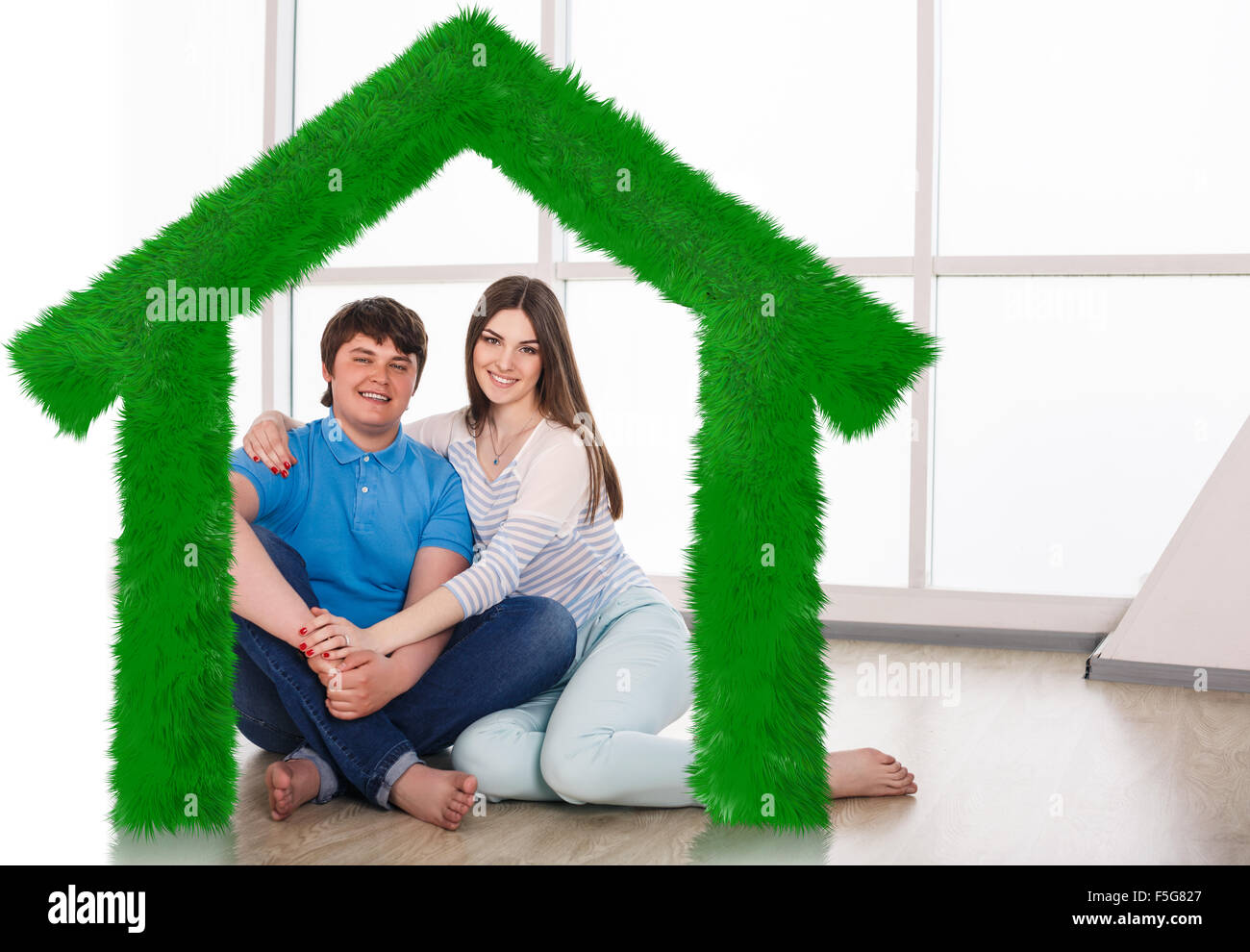 Young cute couple sitting on the floor Stock Photo - Alamy