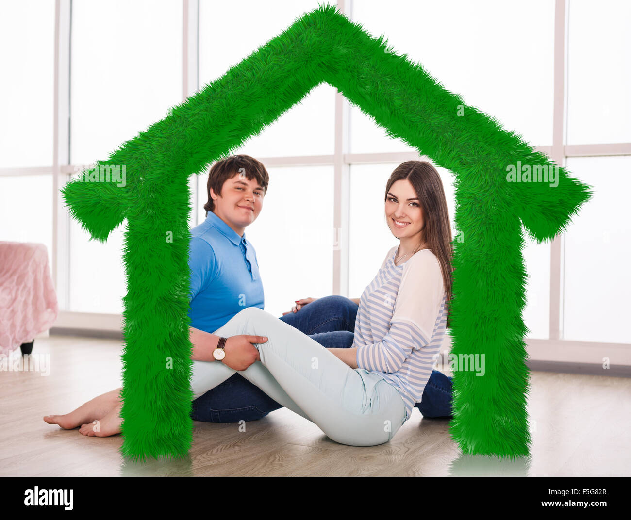 Young cute couple sitting on the floor Stock Photo - Alamy