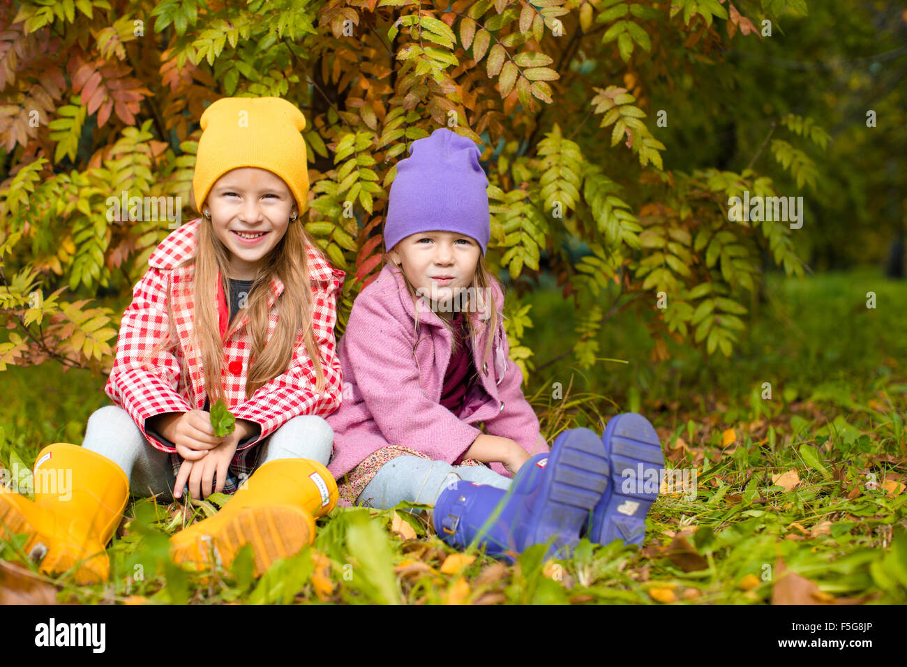 Little adorable girls at warm sunny autumn day outdoors Stock Photo - Alamy
