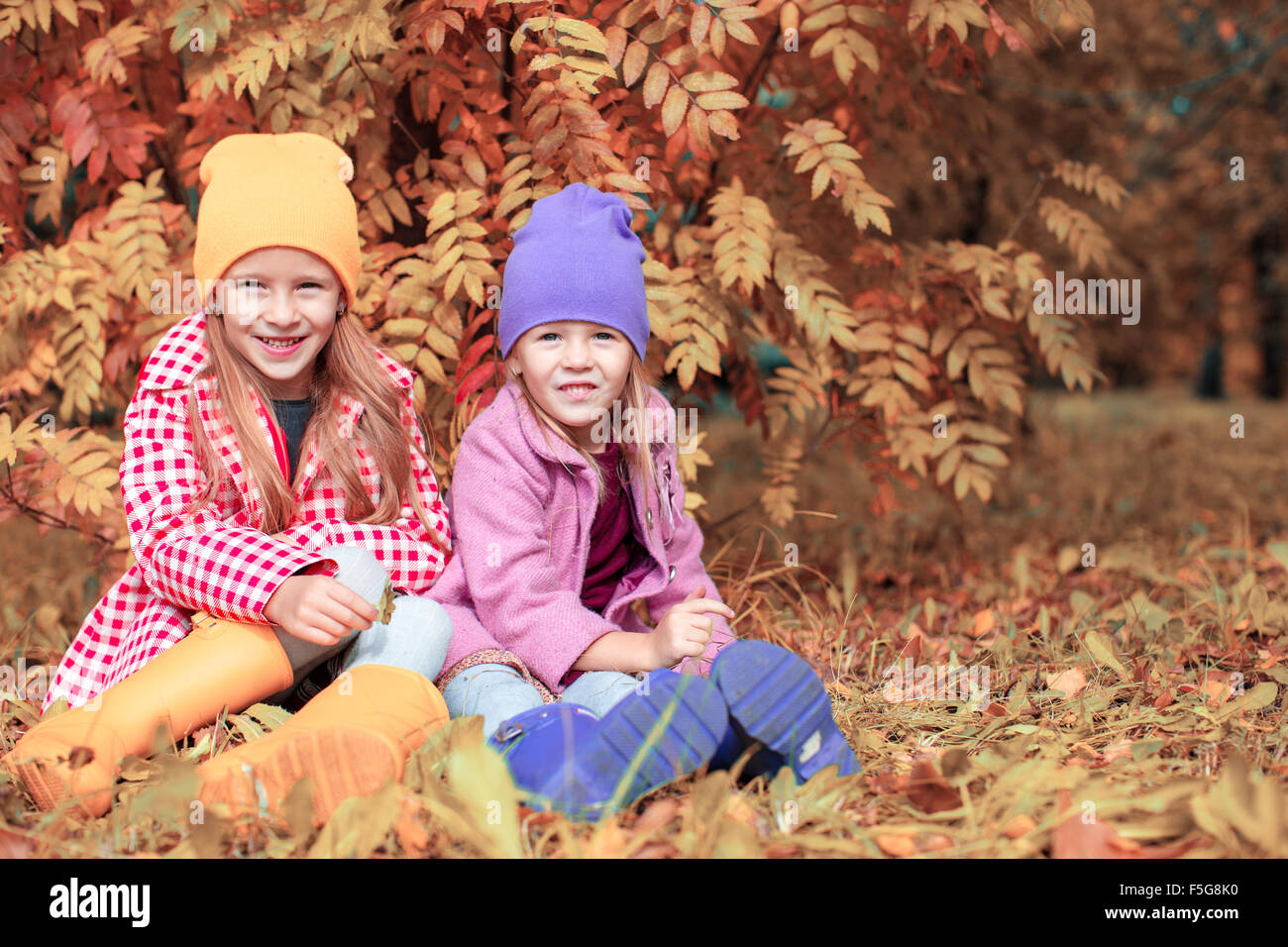 Little adorable girls at warm sunny autumn day outdoors Stock Photo - Alamy