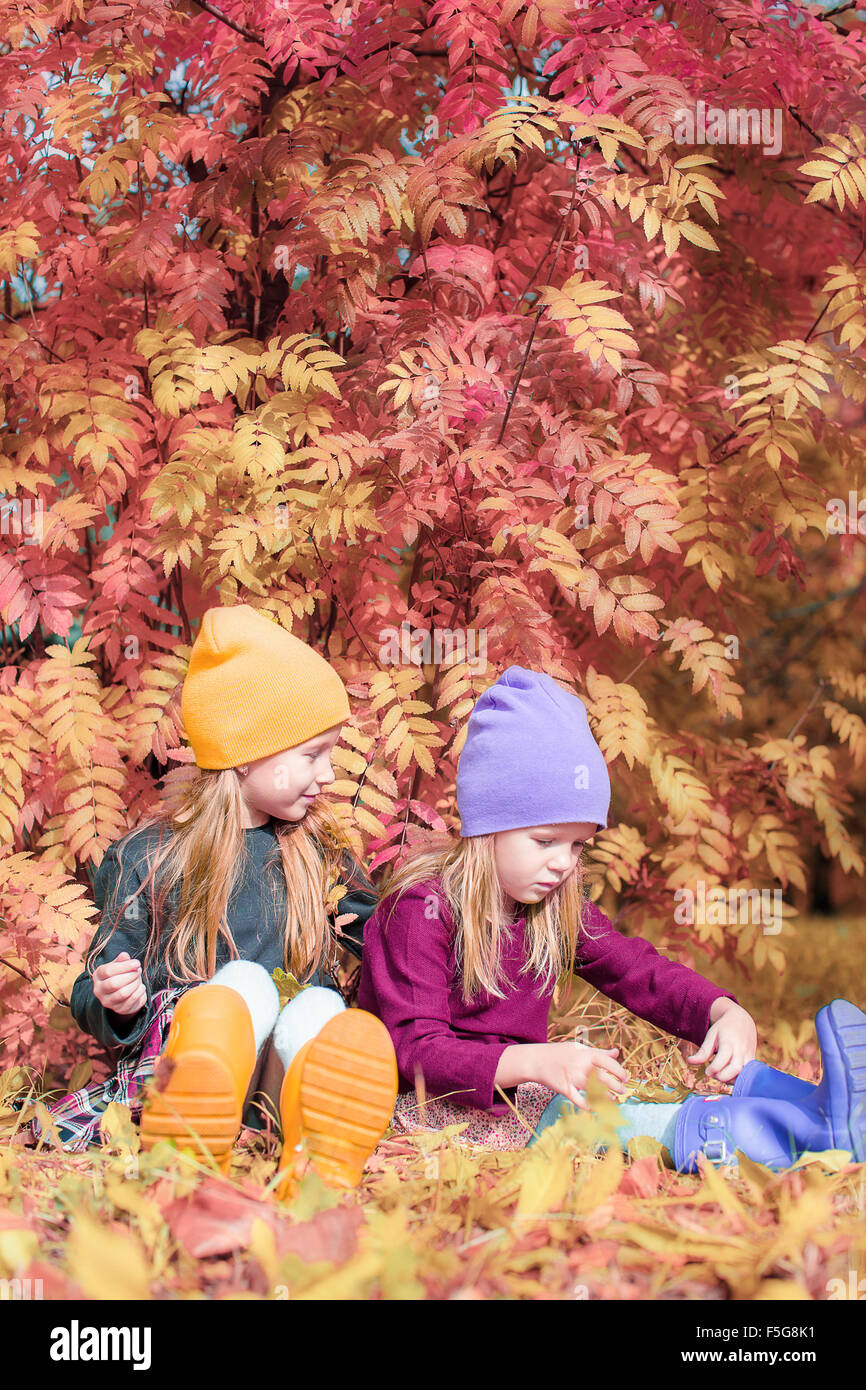 Little adorable girls at warm sunny autumn day outdoors Stock Photo - Alamy
