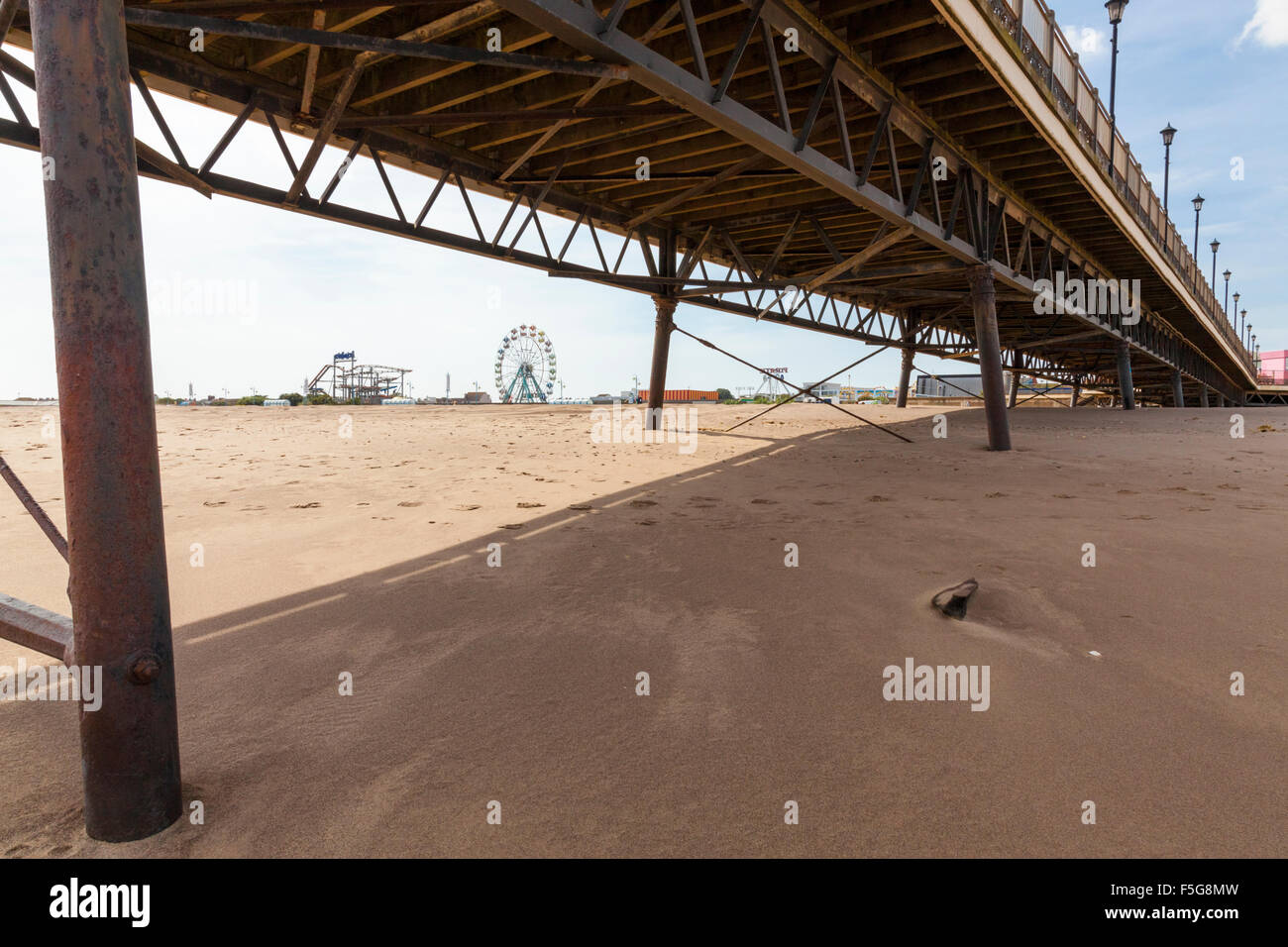 View from underneath Skegness Pier over the beach towards Pleasure Beach fairground, Skegness, Lincolnshire, England, UK Stock Photo