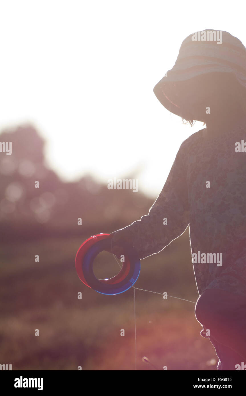 Young girl running holding kite strings Stock Photo - Alamy