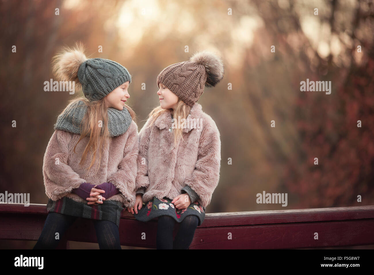 Little adorable girls at warm sunny autumn day outdoors Stock Photo - Alamy