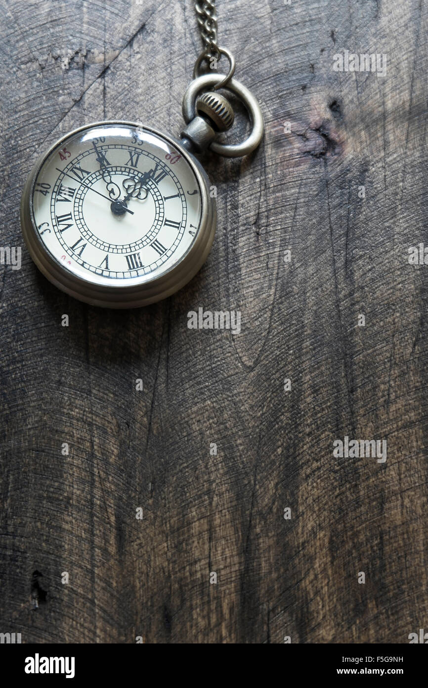 Time - Vintage Pocket Watch on Weathered Wood Background, from above Stock Photo