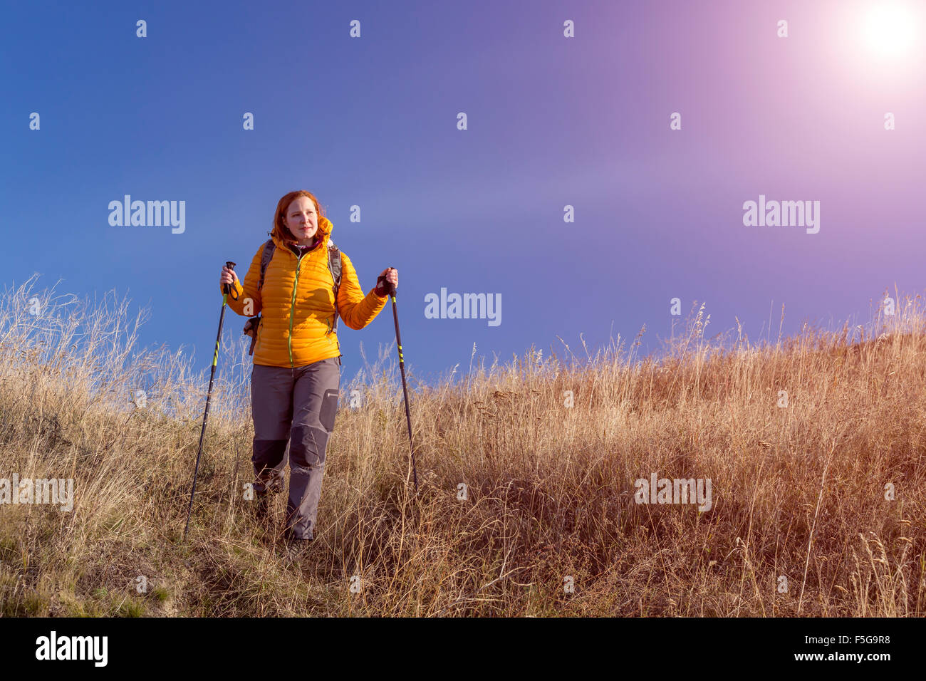Woman walking down hill hi-res stock photography and images - Alamy