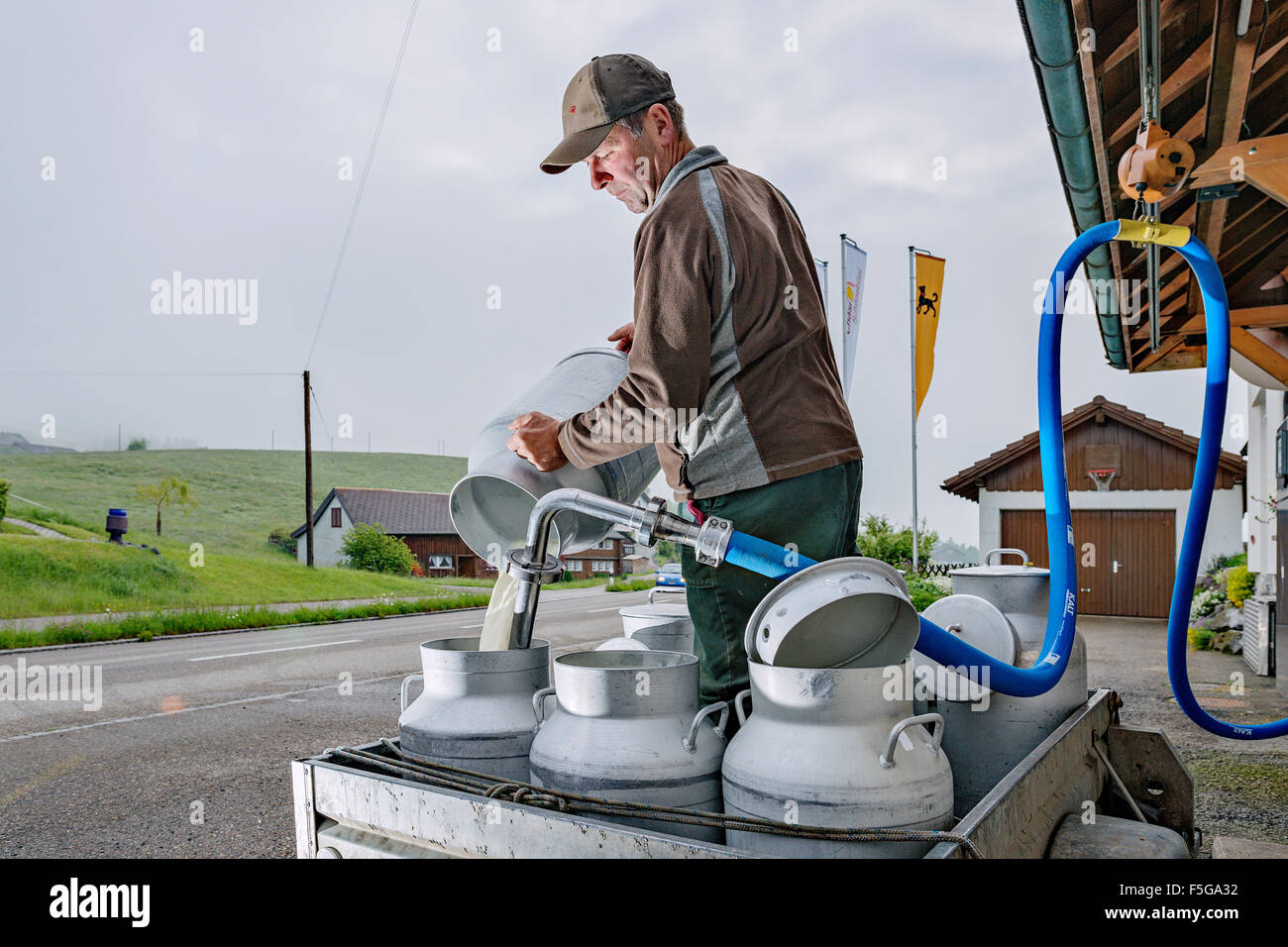 Local farmer bringing fresh milk in the morning to Cheese dairy Nef. Schönengrund, Appenzell, Switzerland. Stock Photo