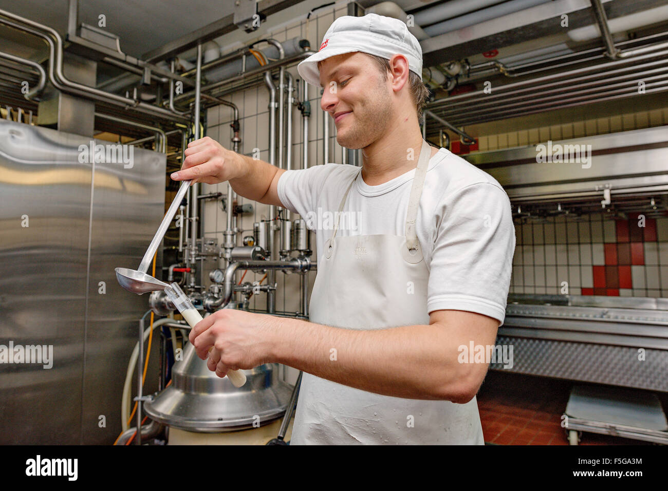 Cheese dairy master taking samples at Cheese dairy Nef. Schönengrund, Appenzell, Switzerland. Stock Photo