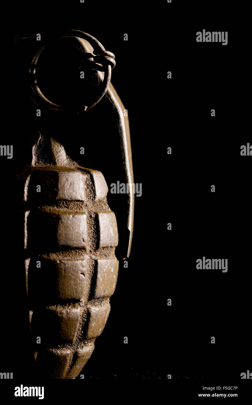 Pineapple grenade as used by U.S. forces during World War Two, against a black background. Stock Photo