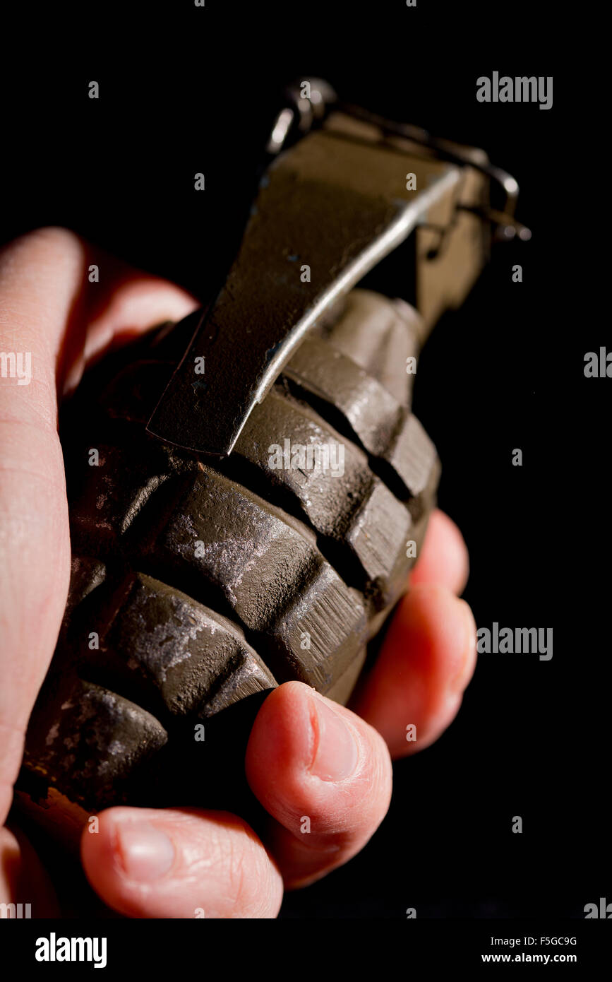 Pineapple grenade as used by U.S. forces during World War Two, against a black background. Stock Photo