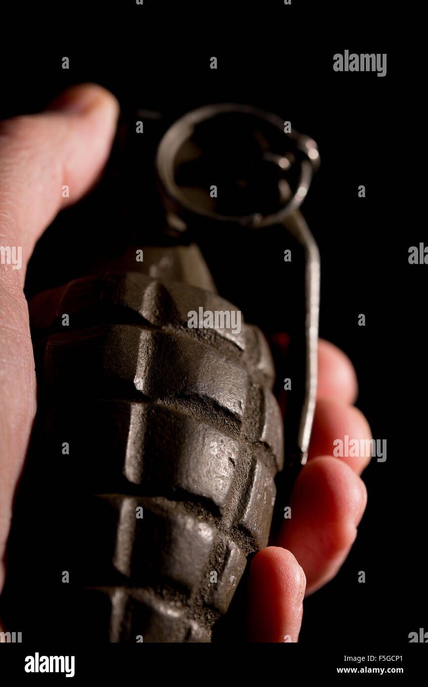 Pineapple grenade as used by U.S. forces during World War Two, against a black background. Stock Photo