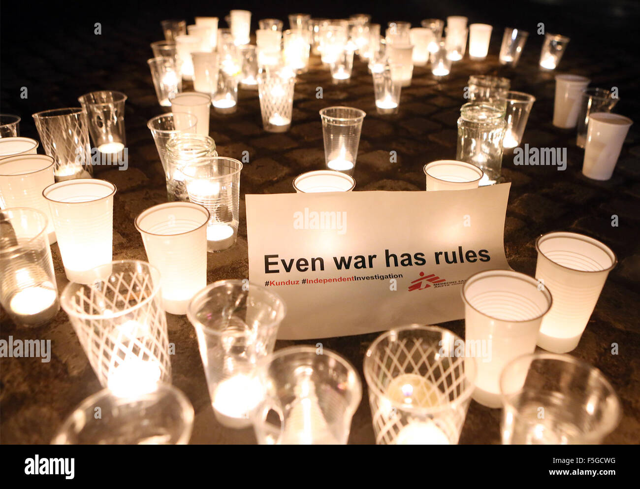 HANDOUT - A Handout datedd 3 November 2015 shows candles burning outside the Reichstag in Berlin, Germany. They are burning as part of a memorial event of the international organisation Doctors without Borders, in the background a banner reads 'Even war has rules'.   A month after the attack on the Doctors without Borderds hospital in the northern Afghan city of Kunduz, organisers among the victims reiterated demand for an independent investigation. Photo:Stephanie Pilick/Ärzte ohne Grenzen/dpa      ATTENTION MUST BE USED WITH MANADATORY CREDIT: Stephanie Pilick/Ärzte ohne Grenzen/dpa Stock Photo