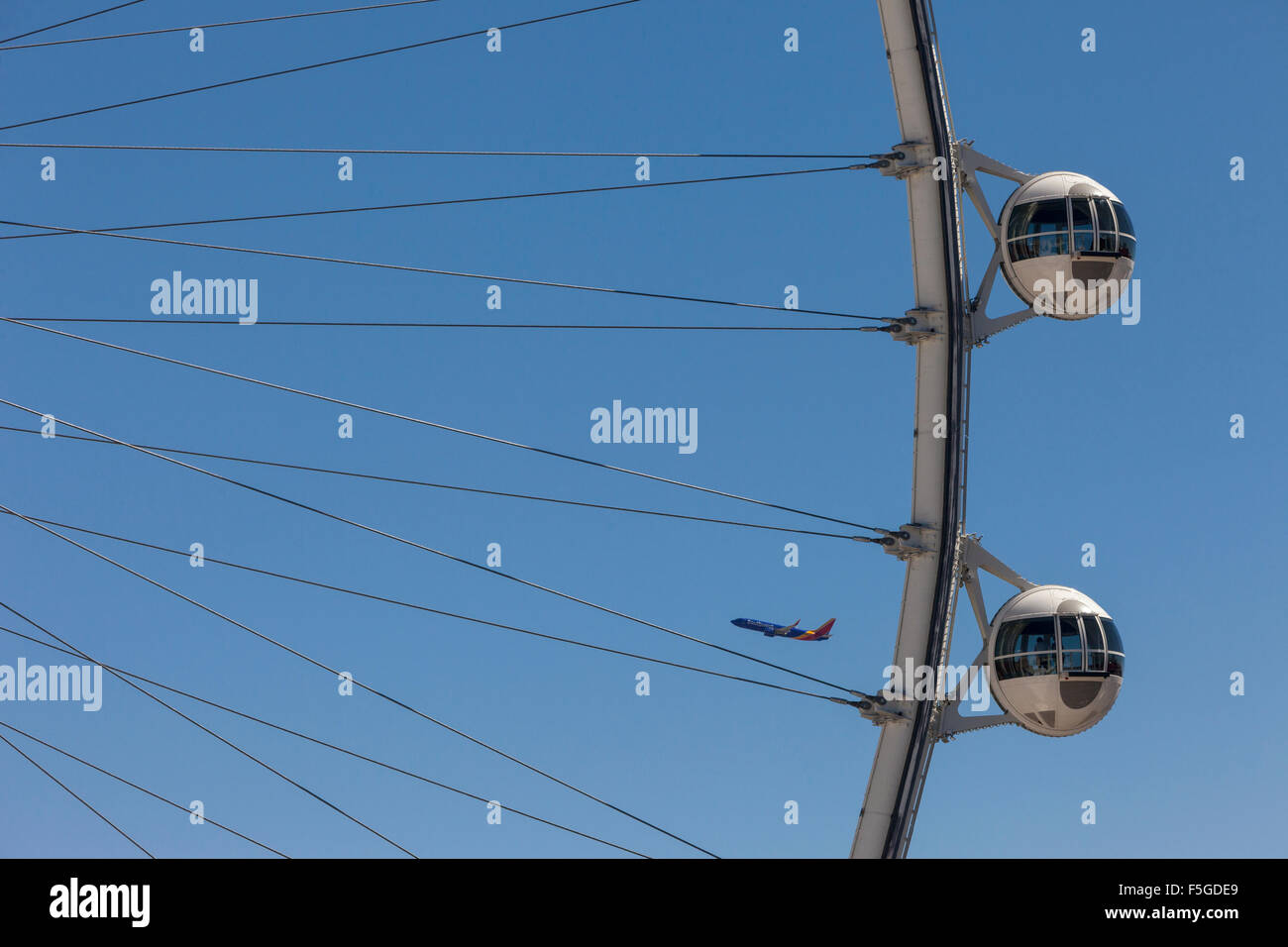 Las Vegas, Nevada.  High Roller, Airplane in Background.  The High Roller is the world's tallest observation wheel as of 2015. Stock Photo