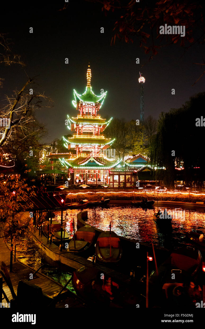 The Dragon Boats in the lake in front of the Japanese Tower restaurant in the Tivoli gardens on a dark Halloween night Stock Photo