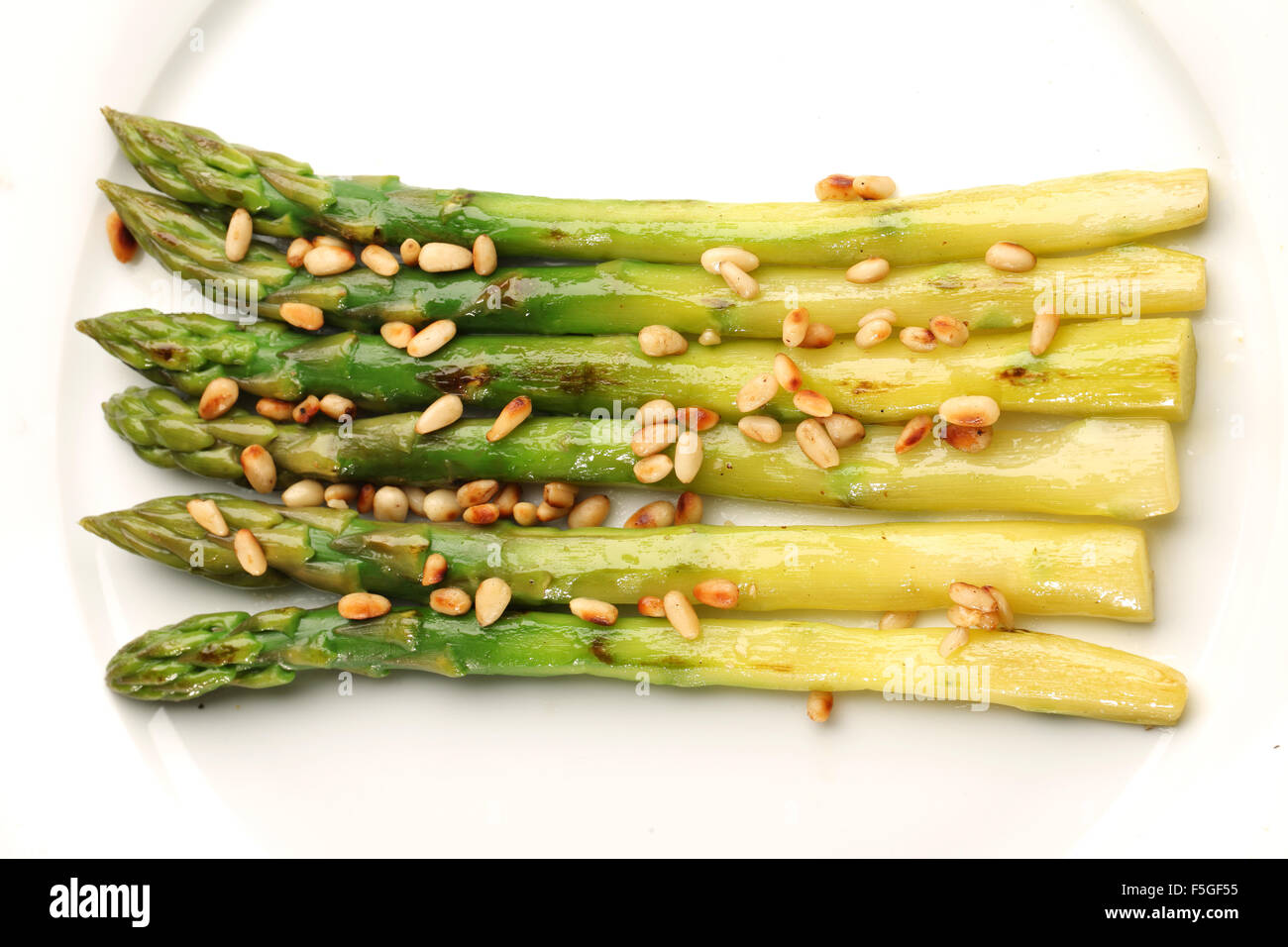 Green asparagus with pine nuts. Stock Photo