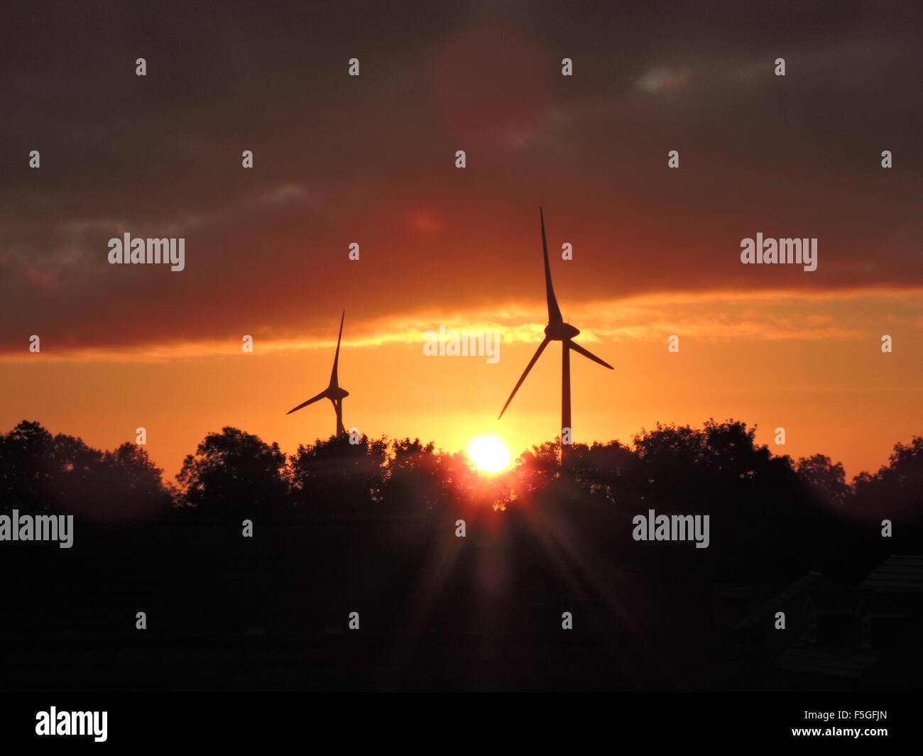 Silhouette of wind turbines during sunrise Stock Photo - Alamy