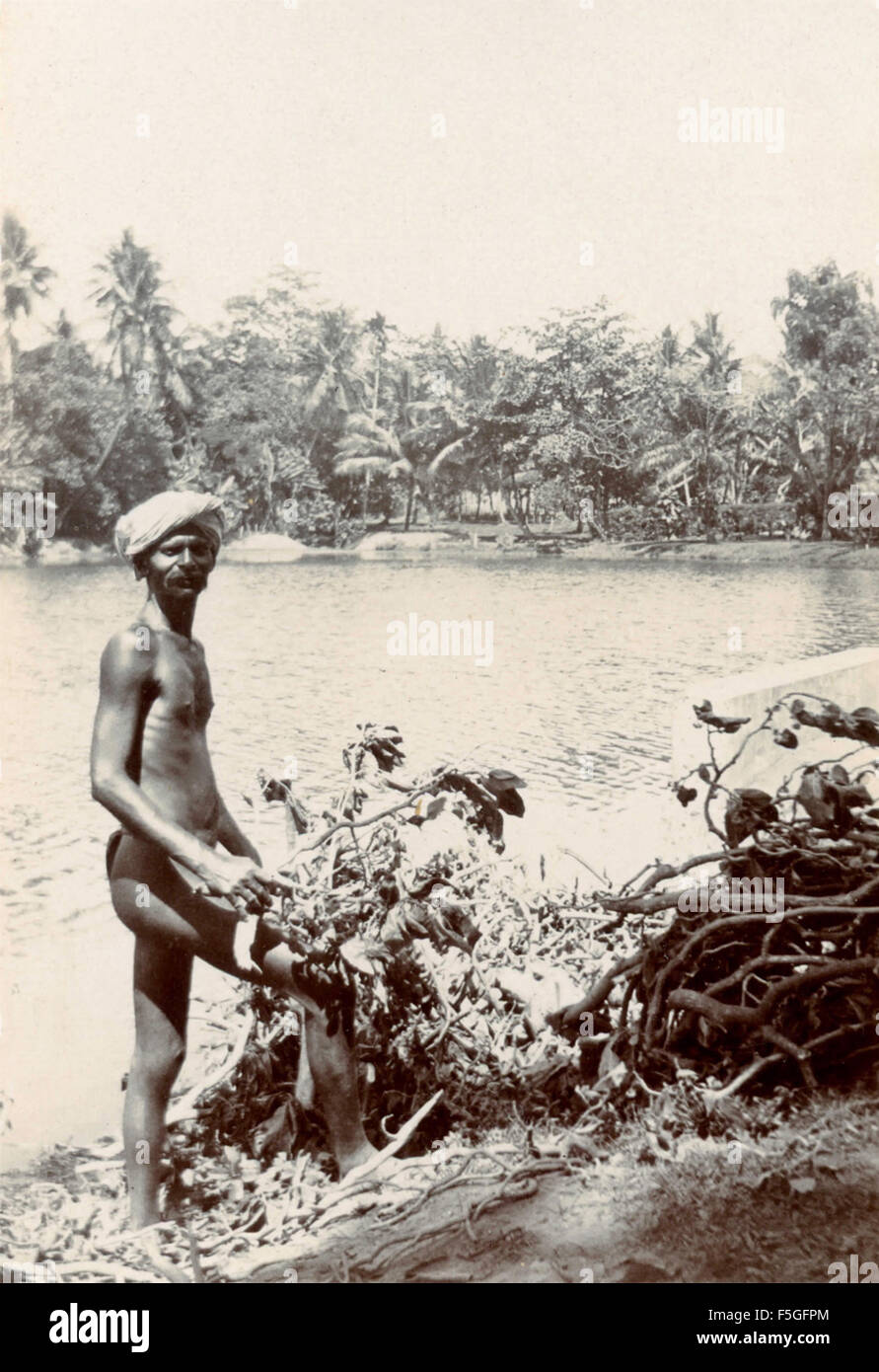Man with thong on the bank of a river, India Stock Photo