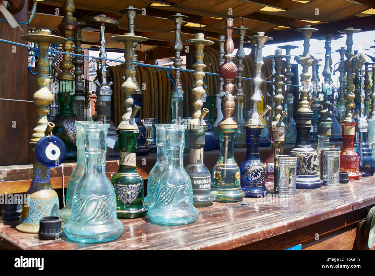 Turkish smoking pipes (hookah) lined up on outdoor bar counter Stock