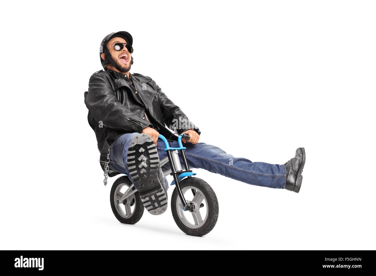 Carefree young biker in black leather jacket riding a small bicycle isolated on white background Stock Photo
