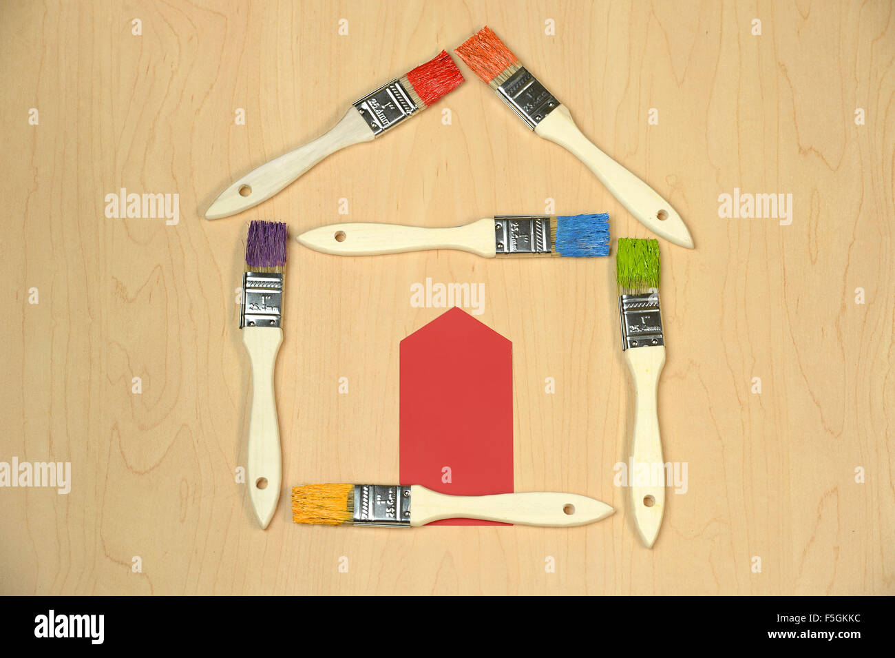 House made out of paintbrushes with different colors and door from color sample Stock Photo