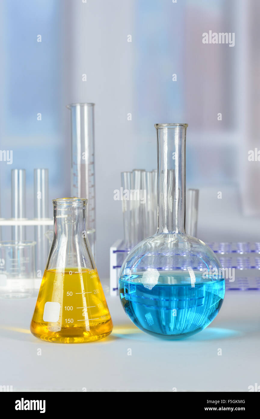 Laboratory glassware with colored liquids on lab table Stock Photo - Alamy