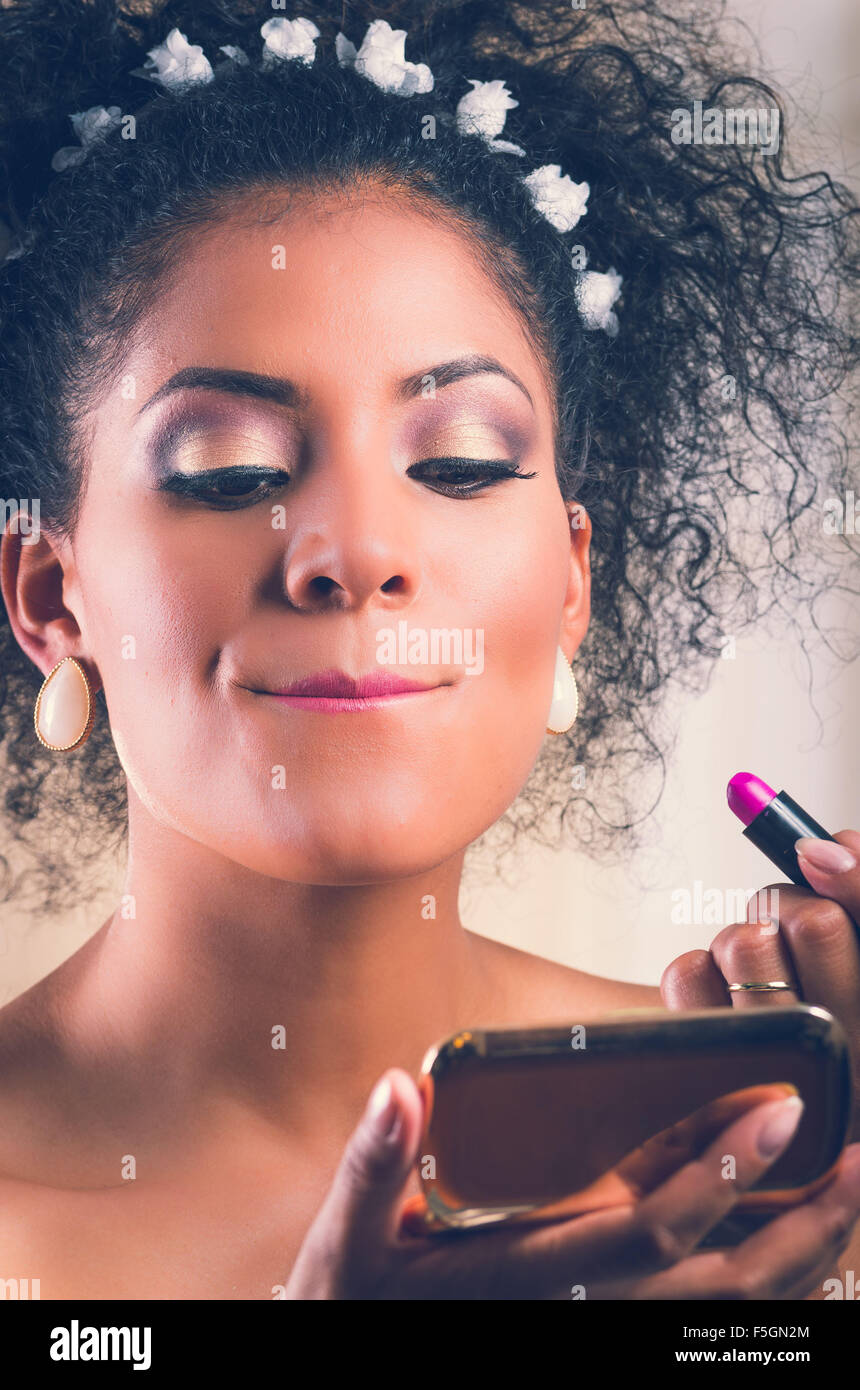 Closeup portrait of beautiful hispanic bride applying makeup on Stock Photo