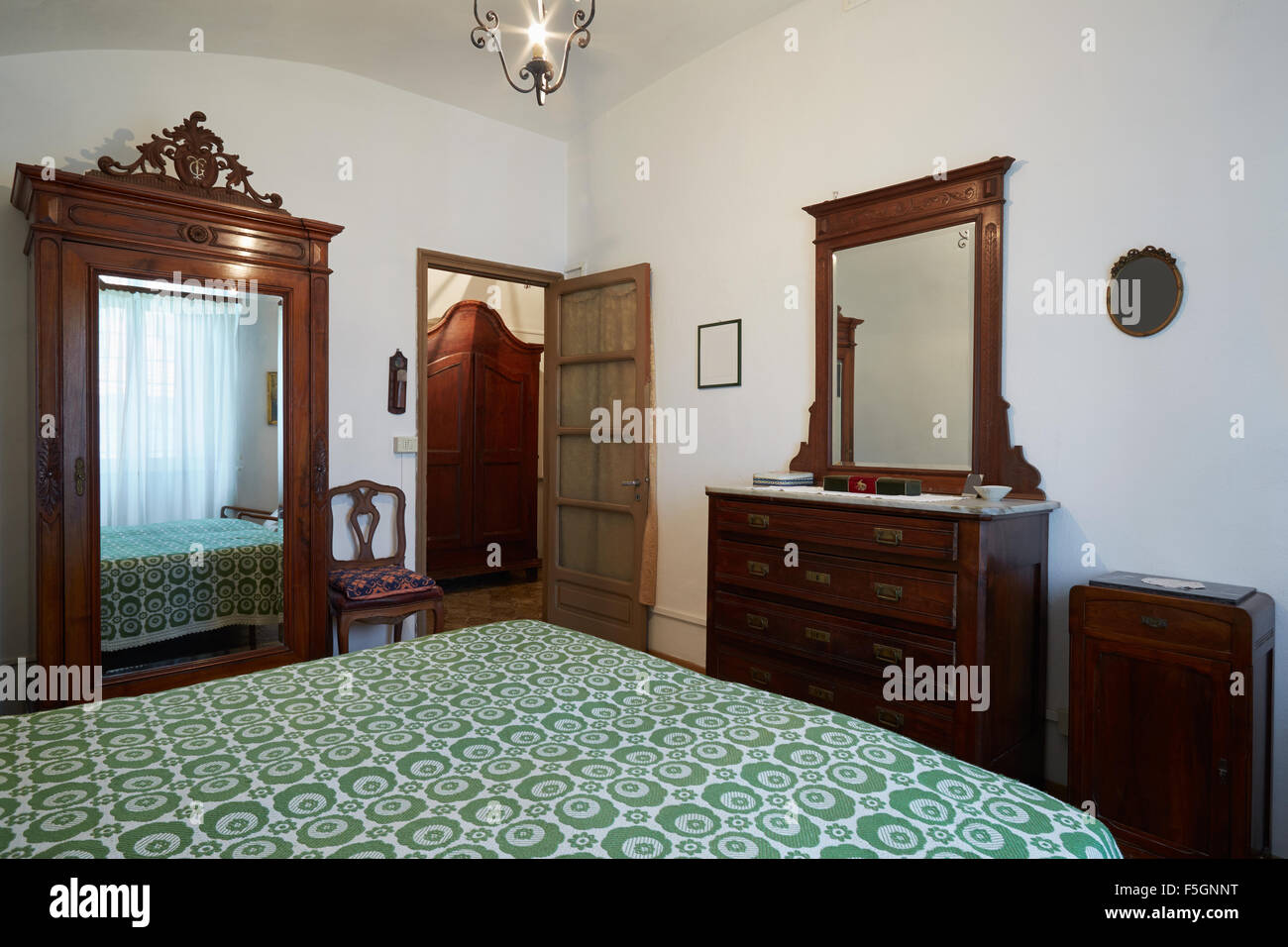 Old bedroom with double bed in ancient house Stock Photo