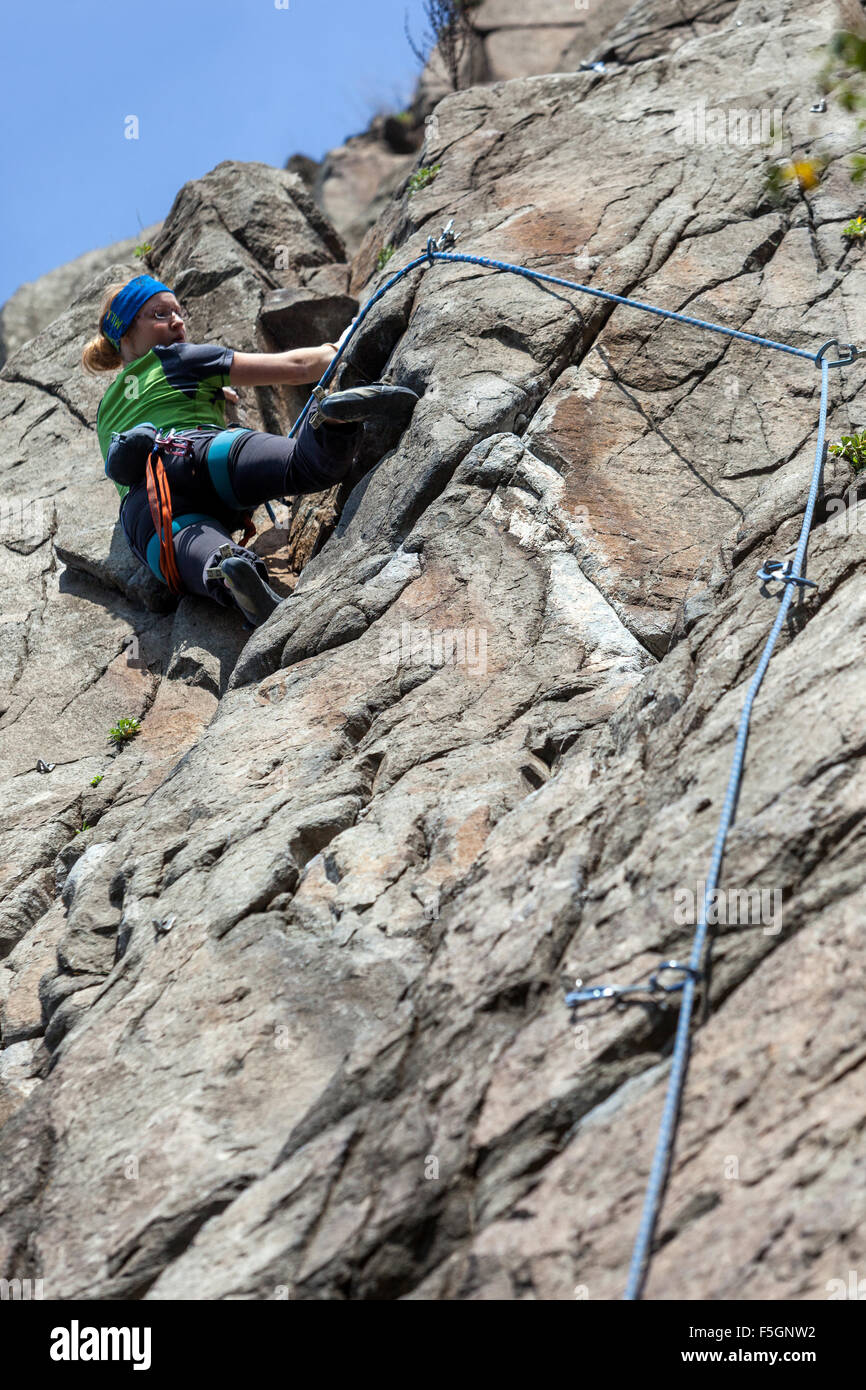 Woman climber climbing up the rock face, Czech Republic Stock Photo