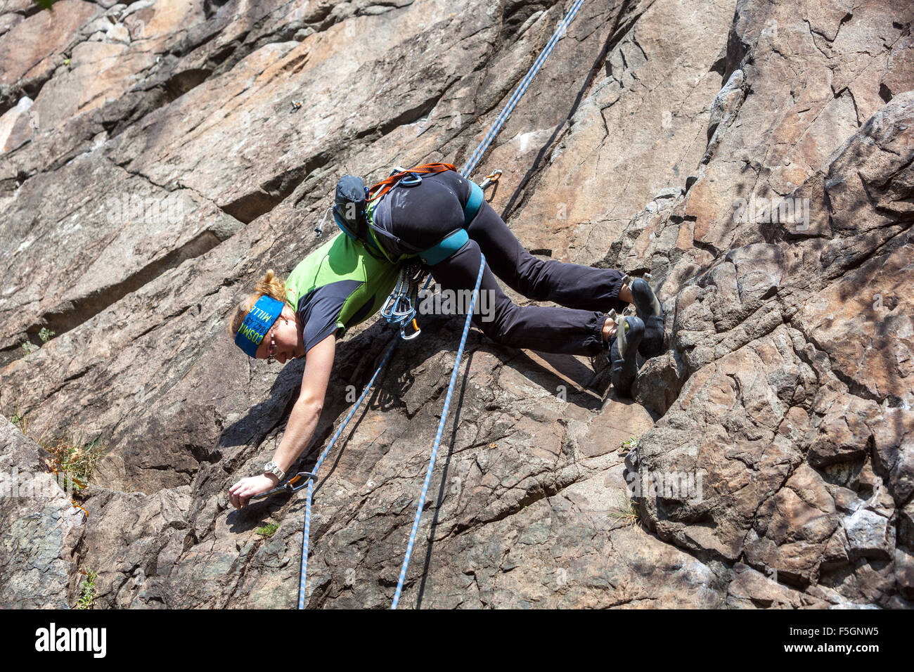 Woman climber climbing up the rock face, Czech Republic Stock Photo