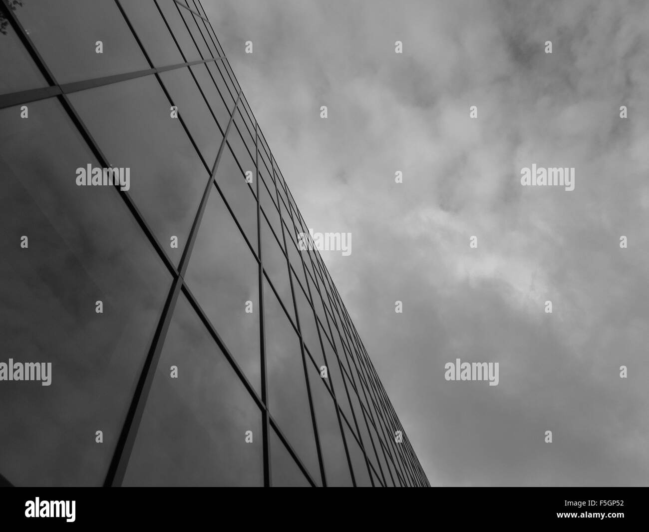 Photograph of a glass building reflecting the clouds in the sky Stock ...