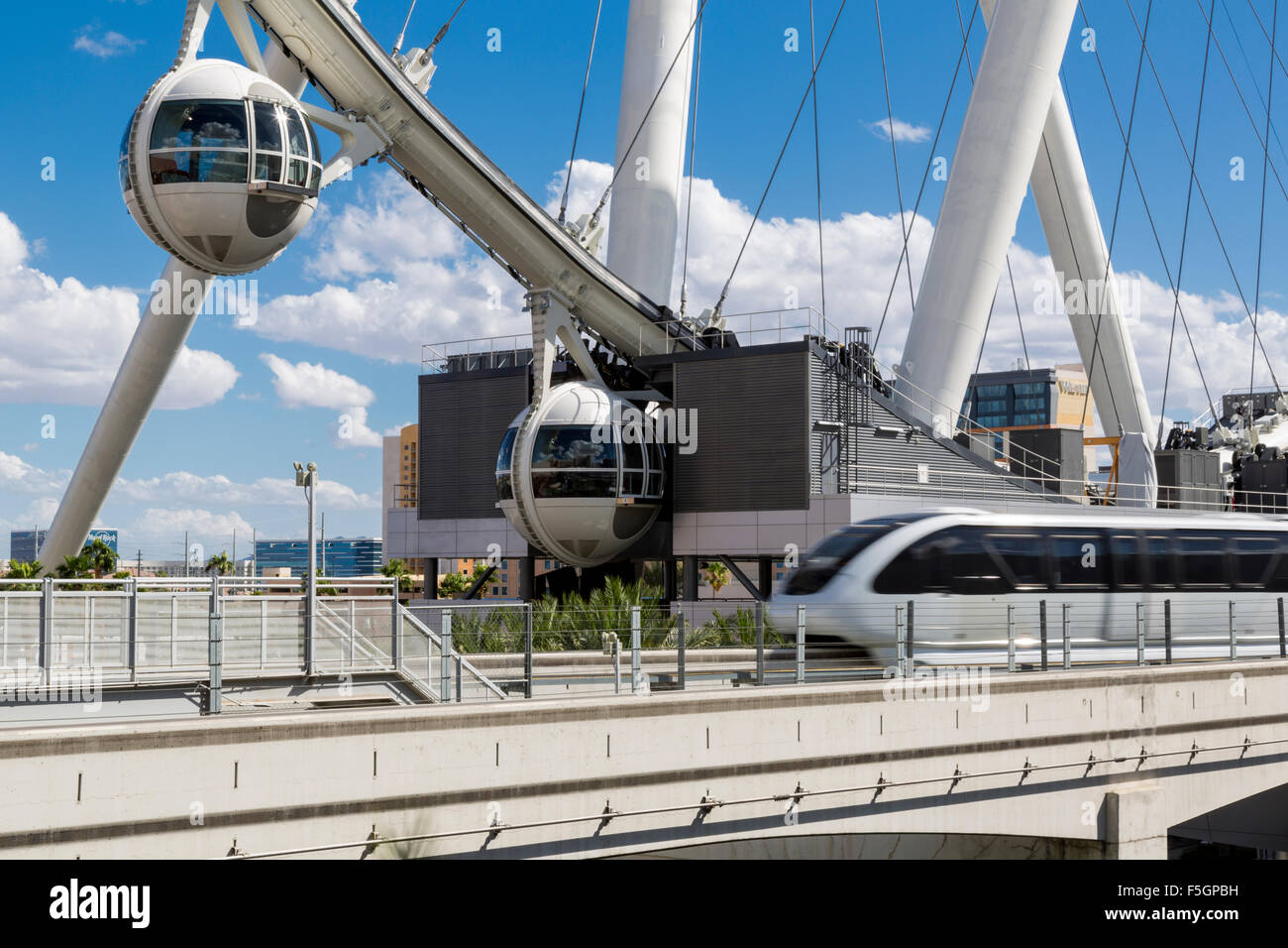 Las Vegas, Nevada.  Monorail Speeds by  High Roller in background, world's tallest observation wheel, as of 2015. Stock Photo