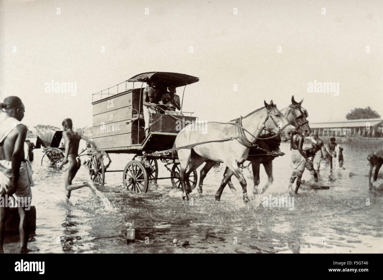 Chariot drawn by horses of the Royal Mail across the river , India Stock Photo