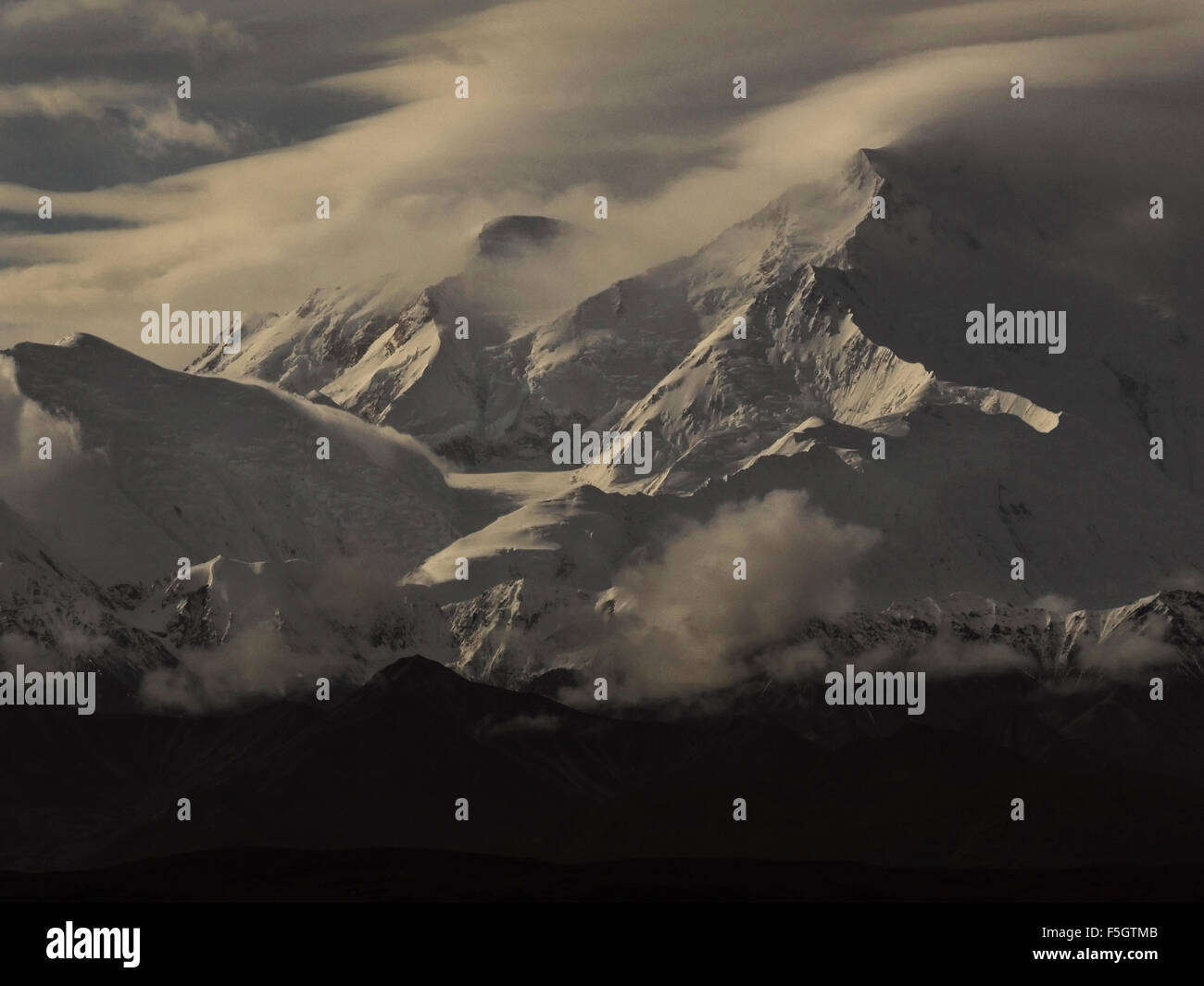 The North Peak, South Peak and Pioneer ridge of Mt. McKinley's summit are visible through the ever present clouds that surround Stock Photo