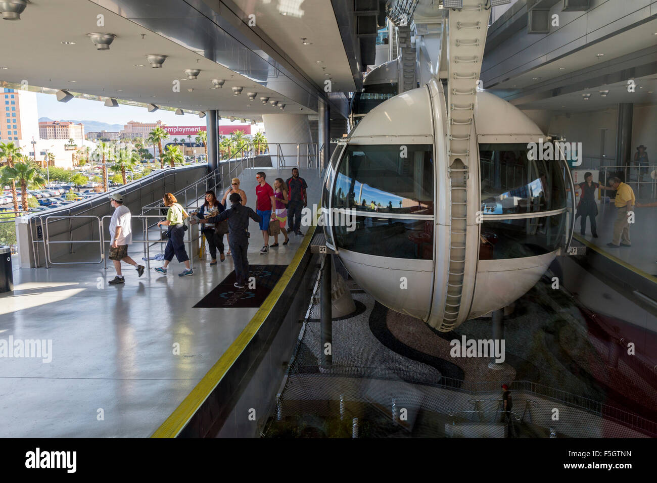 Las Vegas, Nevada.  Passengers Exiting a Gondola on Left as new Passengers Arrive on Right for the High Roller. Stock Photo