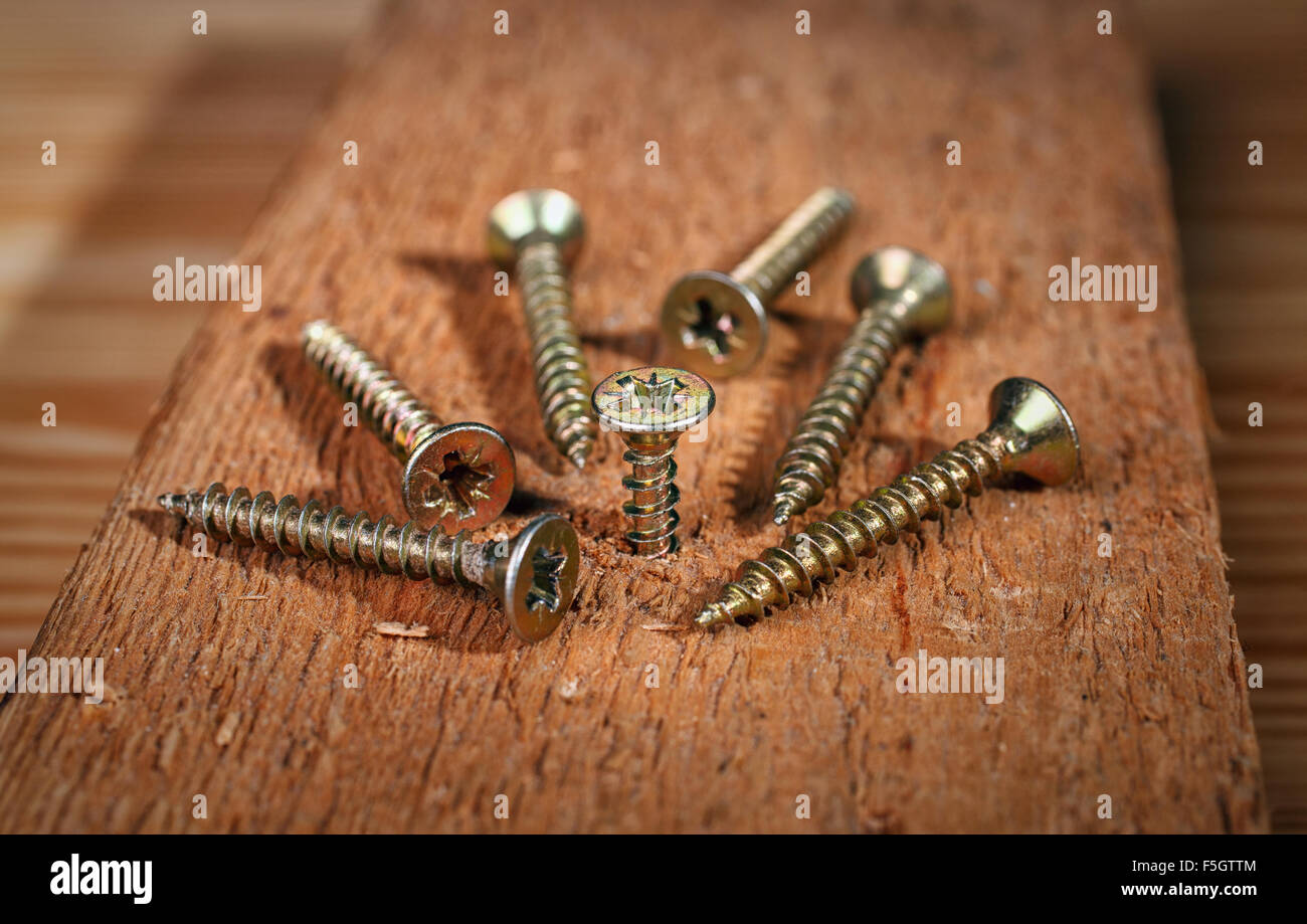 screws on wood background Stock Photo
