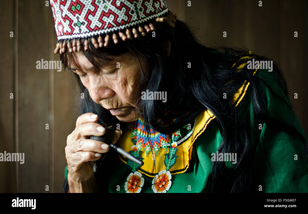 Shipibo shaman  Ynes Sanchez drawing protective arkana trough a mapacho (natural tobacco) smoke Pucallpa, Peru Stock Photo
