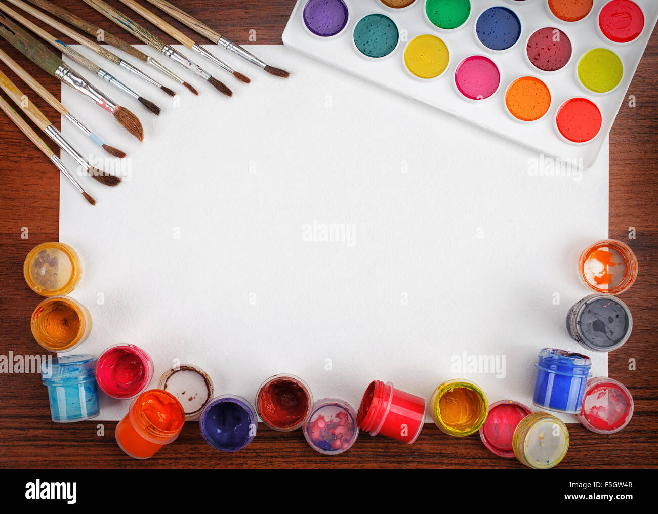 watercolor paints and brushes white blank sheet of paper Stock Photo