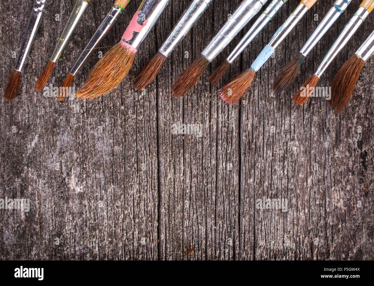 brushes for painting on wooden background Stock Photo - Alamy